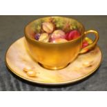 A Royal Worcester matched cabinet cup and saucer painted with fruit, the cup by N Deeley, the saucer