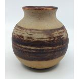 A Stoneware pottery vase signed V or Y Robinson to base.  Standing 15 cm tall and 7 1/2 cm across