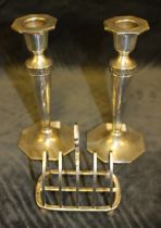 A pair of tapering silver candlesticks with octagonal sconces and bases by Walker and Hall,