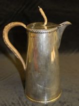 A silver tapering cylindrical hot water jug with rope twist borders, hinged cover, bamboo handle