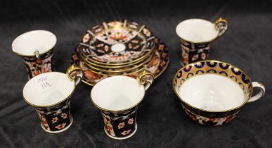 Four Royal Crown Derby coffee cups and three saucers, printed marks 2451 and a further tea cup and