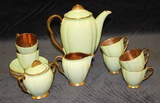 A Carlton Ware coffee service for six in green and gilt including coffee pot, cream jug and sugar