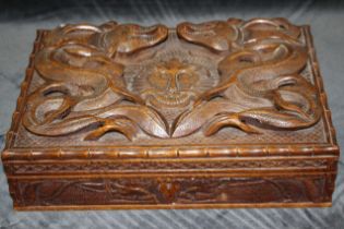 A Burmese wood box carved with dragons, fitted interior,, the interior cover inscribed "with love