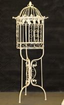 A white ornamental metal birdcage on an integral stand, 109cm high
