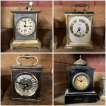 A collection of three carriage clocks (two battery operated) and a small slate mantle clock not