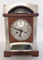 A German oak cased secessionist 14 day strike mantel clock, made in Wurttemburg. with a raised