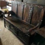 Carved oak settle bench with storage,