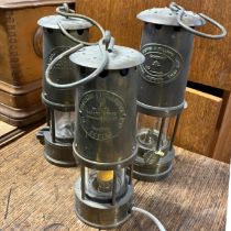 A selection of three miners lamps one has been converted to electric. Two Protector lamp and