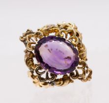 A Victorian amethyst and yellow metal brooch, comprising a large oval mixed cut amethyst, claw set