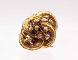 A Victorian amethyst set gold knot brooch/pendant, comprising leaf link decoration set with oval