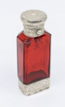 A Victorian silver mounted ruby glass combination scent bottle and vinaigrette, the silver