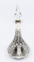 An early 20th Century silver mounted scent bottle, the bottle overlaid with pierced and engraved