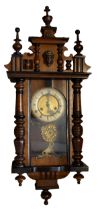 A late 19th/early 20th century mahogany Vienna wall clock of small proportions and with pendulum and