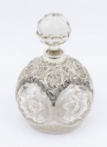 An Edwardian large silver mounted cut glass globular shaped scent bottle and stopper, facet cut star