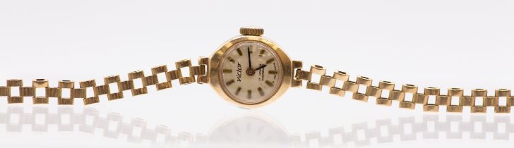 A ladies vintage Victor 9ct gold wrist watch, comprising a round silvered dial with applied baton