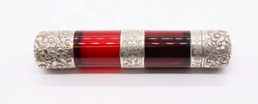 A late 19th Century white metal mounted plain ruby glass double ended scent bottle, the covers