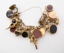 An 19th century unmarked 9ct gold charm bracelet suspending various seals, swivel fobs etc, to
