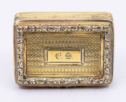 A George IV silver gilt vinaigrette, book shaped ornate scrolling raised border, engine turned