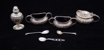 A late Victorian set of three silver condiments comprising  mustard pot with plastic liner, two salt