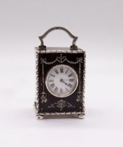 An Edwardian silver mounted tortoiseshell mounted miniature carriage clock, the case with bell