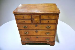 A walnut and mahogany reproduction tv cabinet in the style of George III chest.