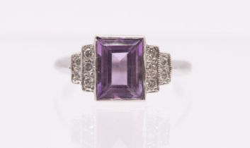 An amethyst and diamond platinum ring, the centre rectangular cut light purple amethyst measuring