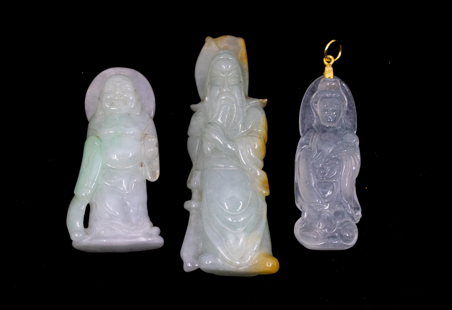 A collection of jadeite type items to include a carved pendant suspended from a two tone chain,