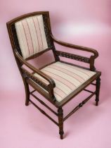 A late Georgian mahogany armchair with turned supports and legs, fretwork detail to sides and back