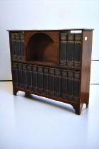 A early 20th Century small oak bookcase with complete collection of 18 volumes of Charles Dickens