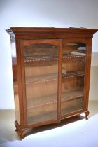 An early 20th Century mahogany display/book cabinet with three internal shelves behind two glazed