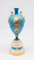 Royal Worcester - A tall twin handled urn vase, on elaborate stepped footed base, the body having