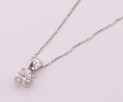 A diamond and 9ct white gold pendant and chain, comprising a round brilliant cut diamond weighing