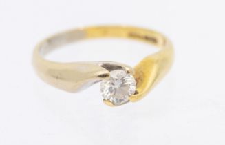 A diamond and 18ct gold two tone ring, comprising a claw set round brilliant cut diamond weighing