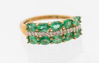 An emerald and diamond 9ct gold dress ring, comprising a double row of oval mixed cut emeralds, each