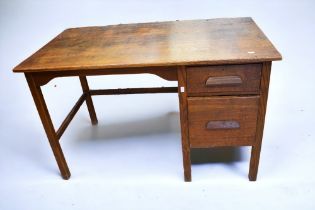 A 1930s oak desk with two side drawers along with an early 20th Century oak timber front pedestal