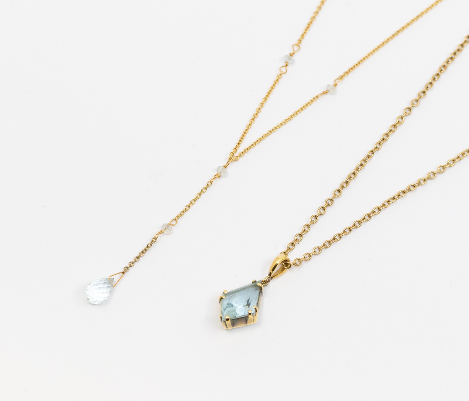 An aquamarine and 18ct gold drop necklace, comprising a fine gold chain set with two small