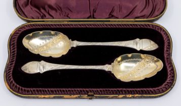 A pair of Victorian Aesthetic silver berry / serving spoons, the handles engraved with birds and