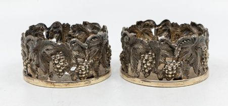 A pair of Continental 925 silver wine coasters, the sides cast with trailing vine leaves, the