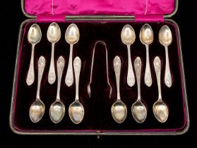 A late Victorian/early Edwardian set of twelve silver teaspoons, with matching sugar tongs, the