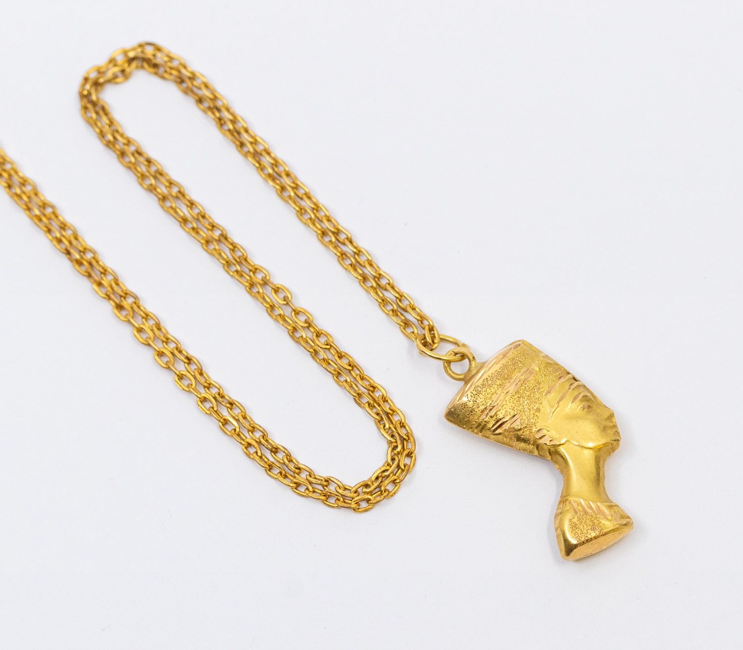 An Egyptian gold pendant in the form of Nefertiti, Egyptian gold mark for 18ct, weight approx 2.6gms