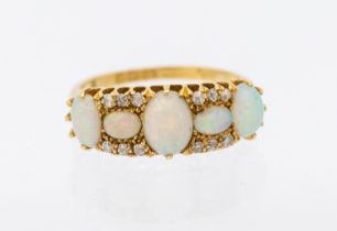 ***AUCTIONEER TO ANNOUNCE CHIP TO ONE SMALLER OPAL**** An opal 18ct gold ring, comprising
