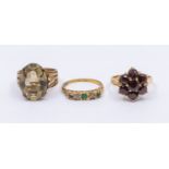 A collection of three gold stone set rings, comprising a garnet flower cluster, diameter approx