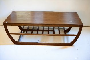 A teak 1970's coffee table with rack effect shelf underneath. date stamp for December 1971