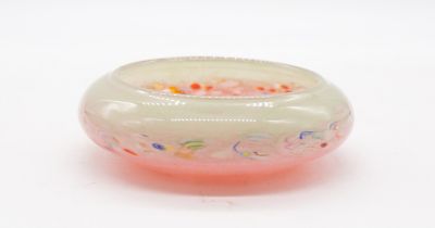 A Monart 20th century small glass circular bowl, having various coloured speckles throughout green