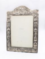 An early 20th Century Asian probably Indian silver (untested) large frame, the domed top chased with