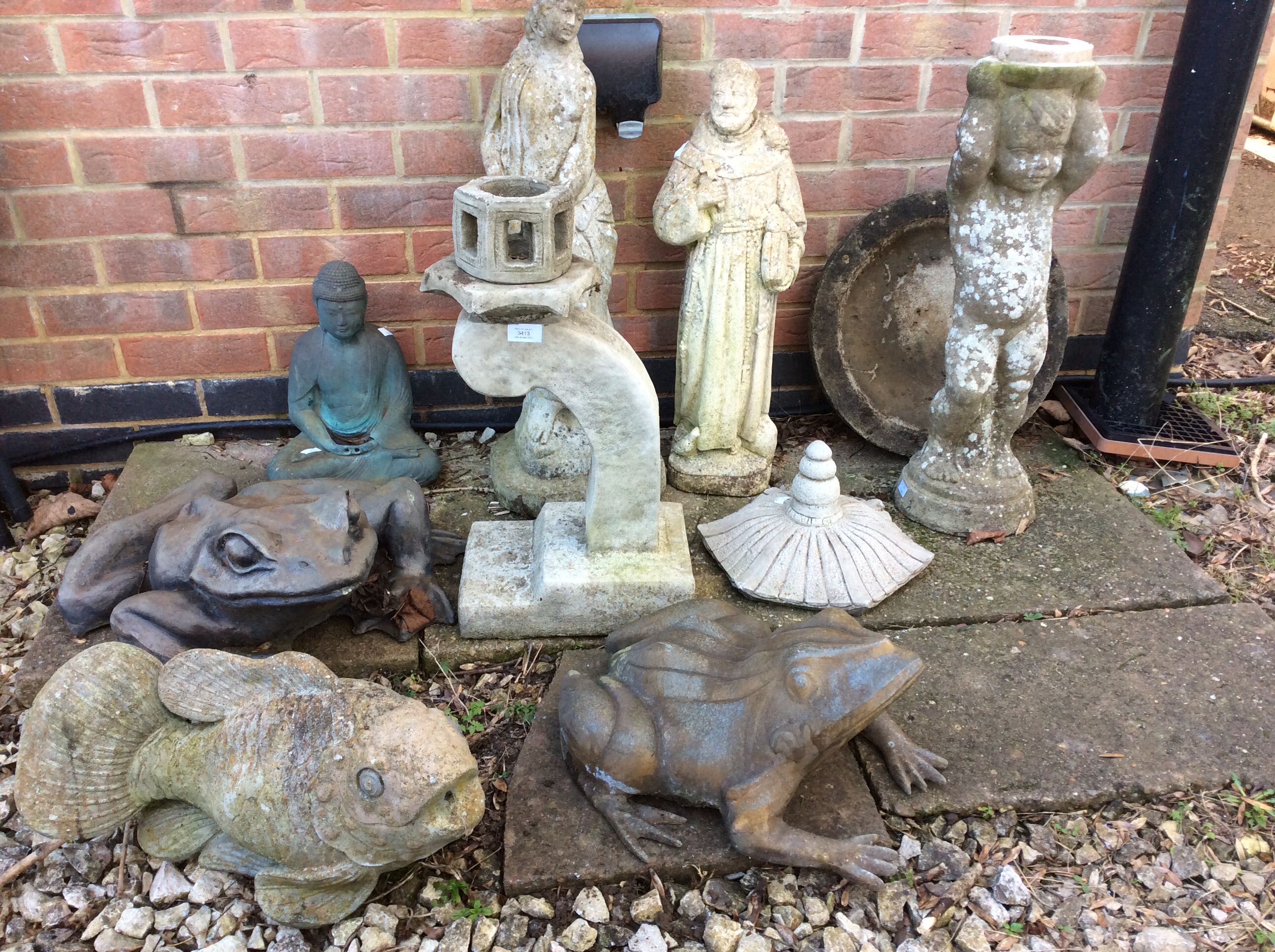 A collection of resin and concrete composite garden ornaments to include frogs, fish, cherub and