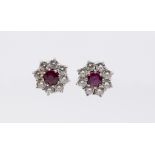 A pair of ruby and diamond 18ct white gold cluster earrings, the centre set with a round mixed cut