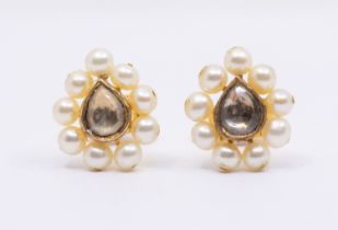 A pair of gold pearl and white stone set earrings, possibly white sapphire, comprising a pear shaped
