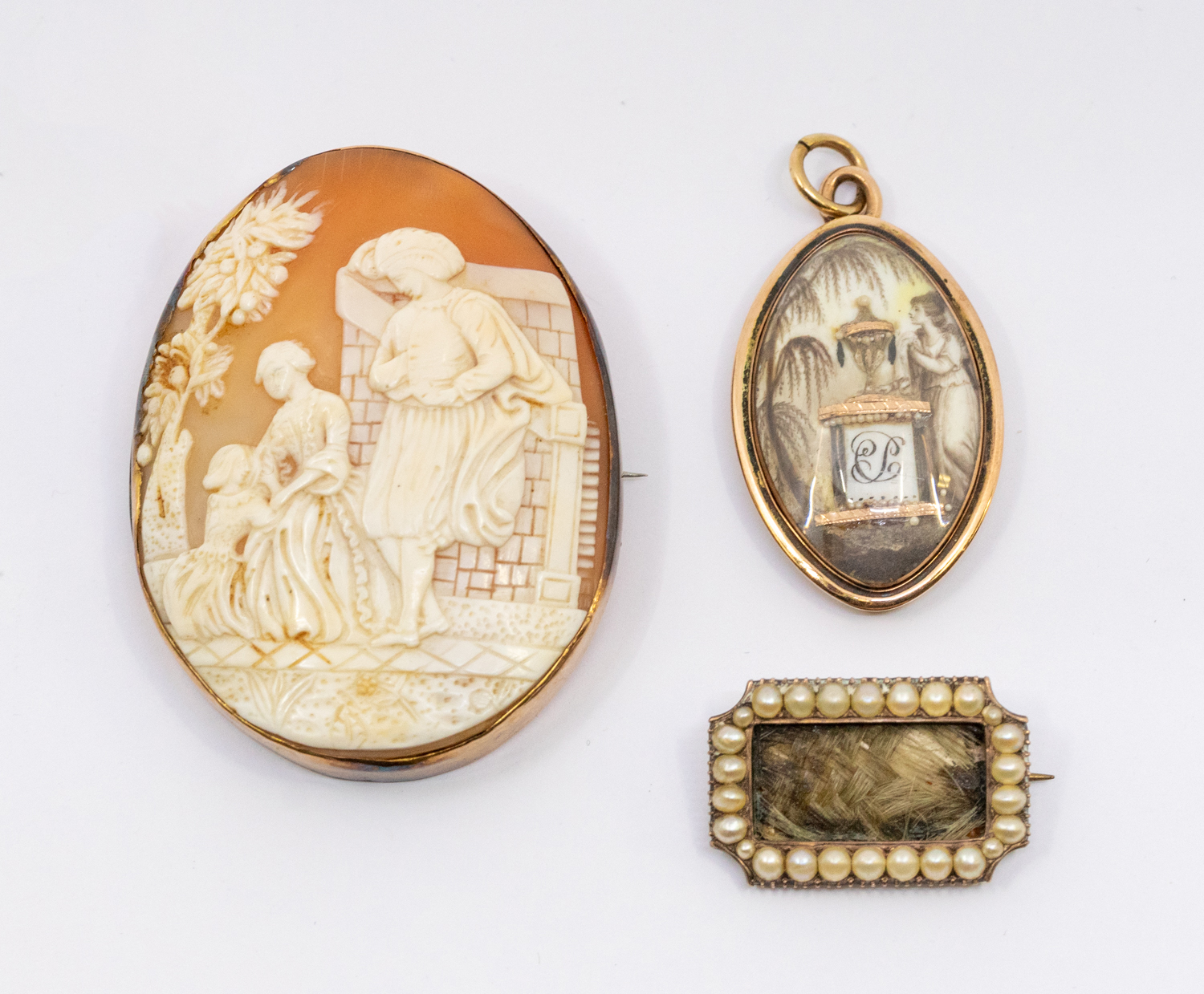 A Georgian gold pendant inset with a mourning miniature depicting a Classical lady beside a grave