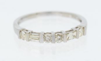 A diamond 14ct white gold ring, comprising six diamonds set to a half half hoop, set four